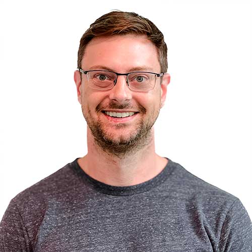 Headshot of male Architect wearing a gray long sleeve top