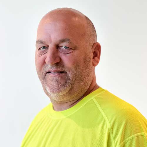 Headshot of male carpenter wearing a neon green construction t shirt.