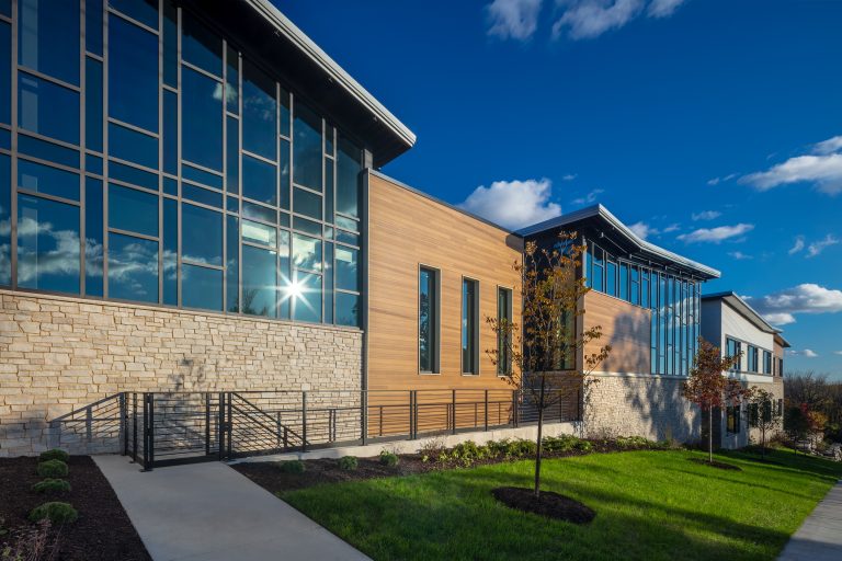 photo-Close up exterior of academy featuring large windows and the building shape