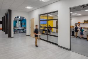 Photo-School Cafeteria with student carrying lunch tray