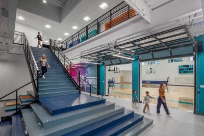 photo-Large staircase that expand to the garage door entrance of gym