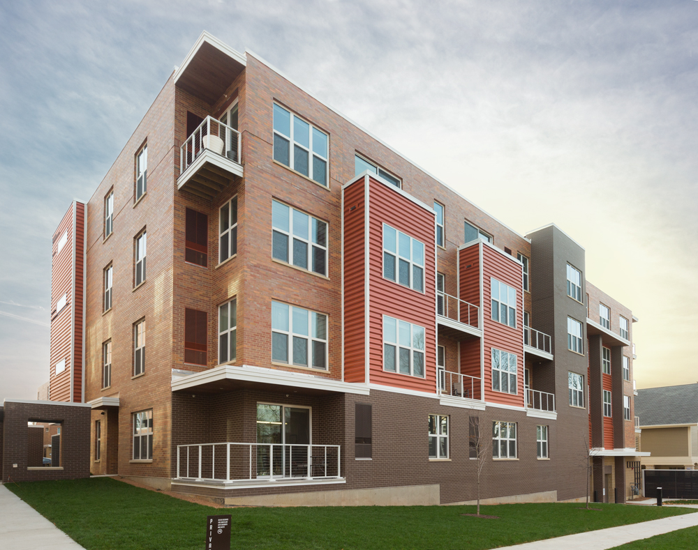 Exterior of apartment with orange, dark brown and light brown exterior siding