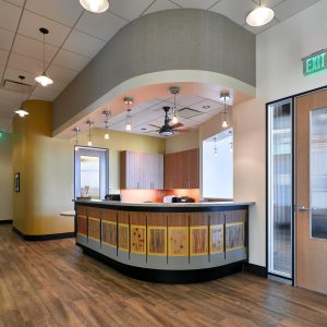 Dental office curved reception desk with with curved ceiling and wood floors