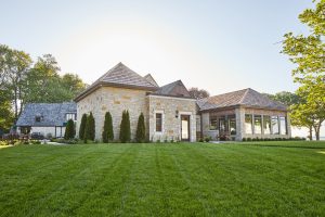 Exterior shot of country club with clean up grass, cream colored bricks