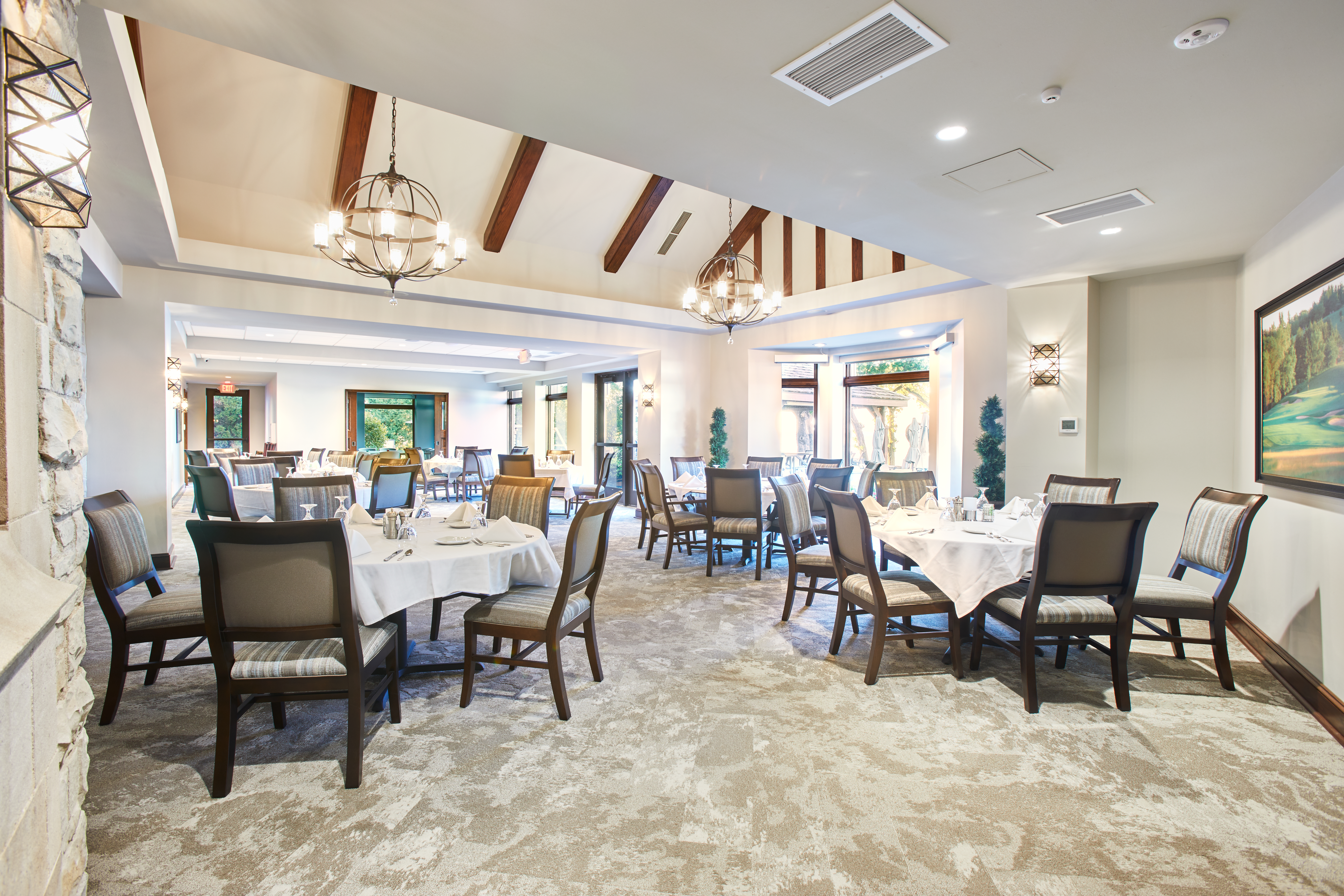 angled shot of restaurant seating area with high peaked ceilings and natural lighting