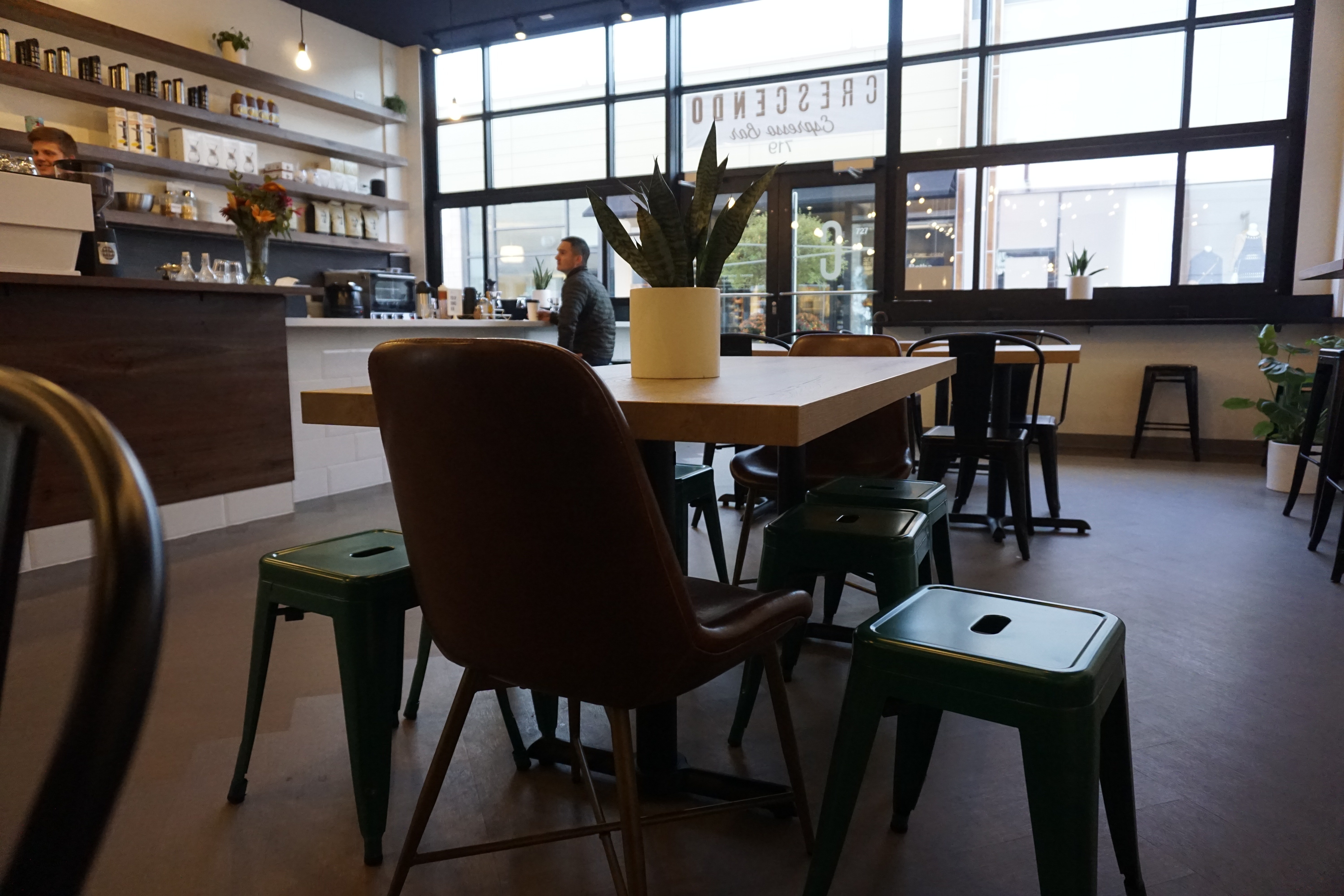 Espresso bar wood top table with different type of metal chairs and leather chairs