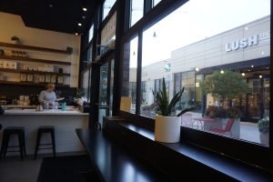 Looking out window in espresso bar with bar height seating near the window