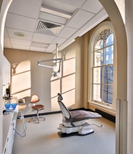 Dental operatory with arched entry and expansive window with natural light