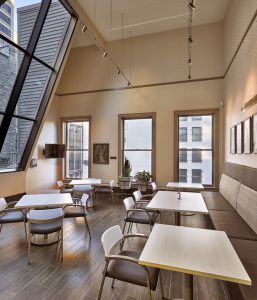 Dental waiting area with tables large ceiling to floor windows