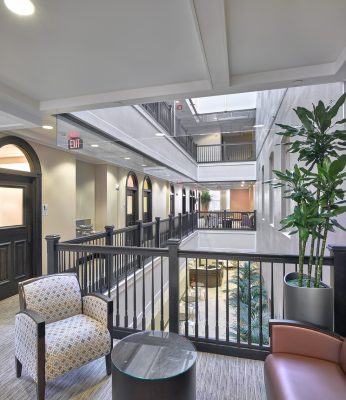 Dental waiting area with open atrium chair railing and seating