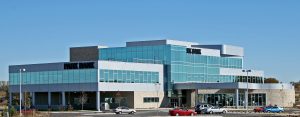 A modern, multi-story building with large glass windows