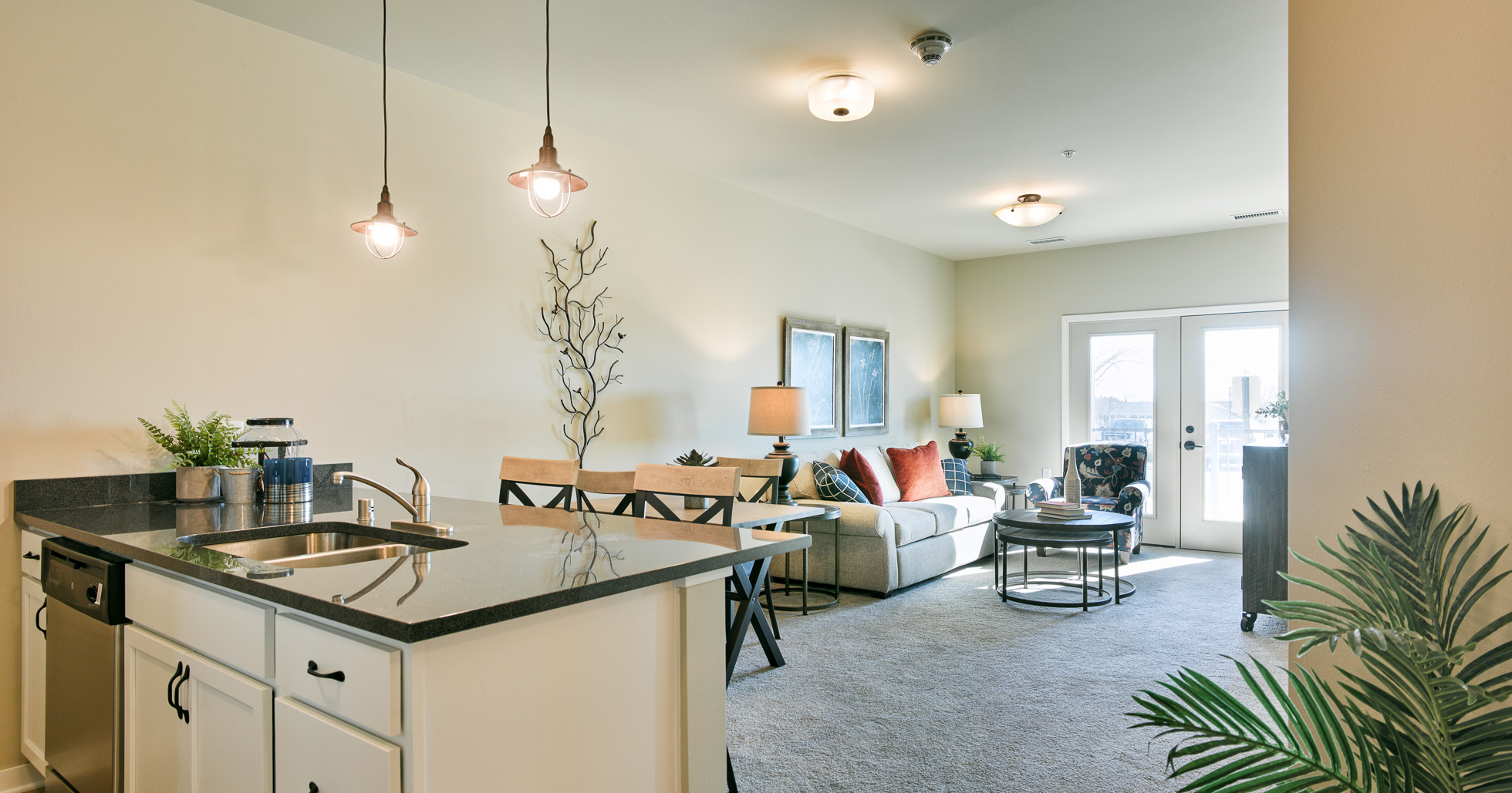 Senior living apartment with kitchen Island looking into the living room