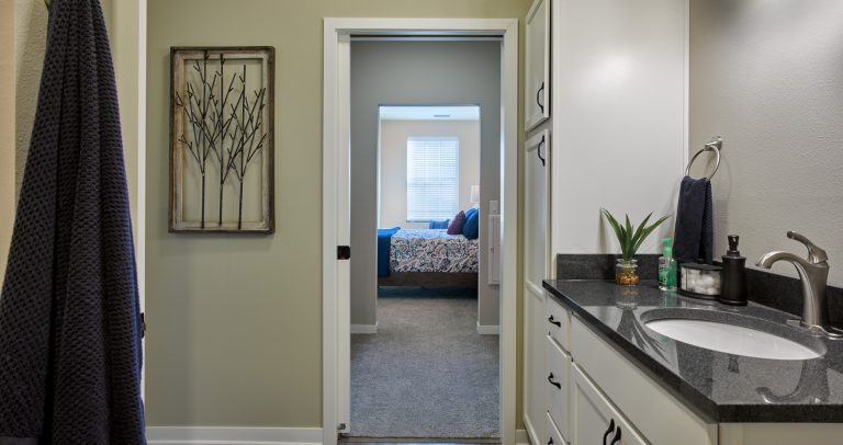 Senior living apartment with view from bathroom looking into the bedroom