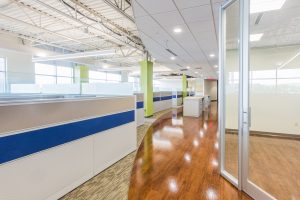 modern, well lit office cubicle area with light gray cubicles