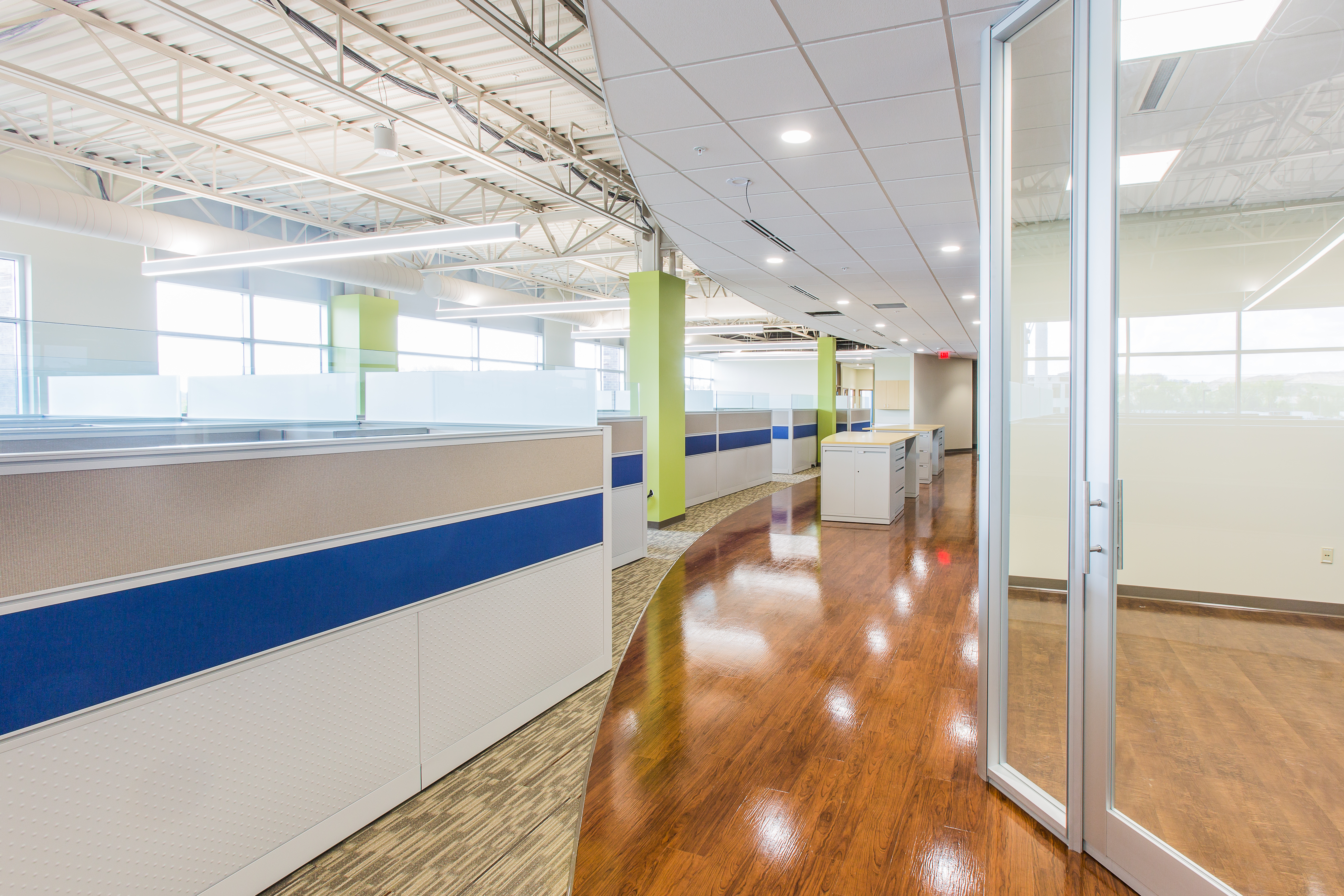 modern, well lit office cubicle area with light gray cubicles