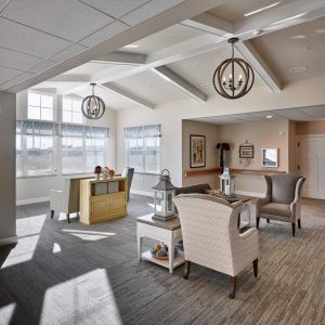 Seating area with vaulted ceiling and windows