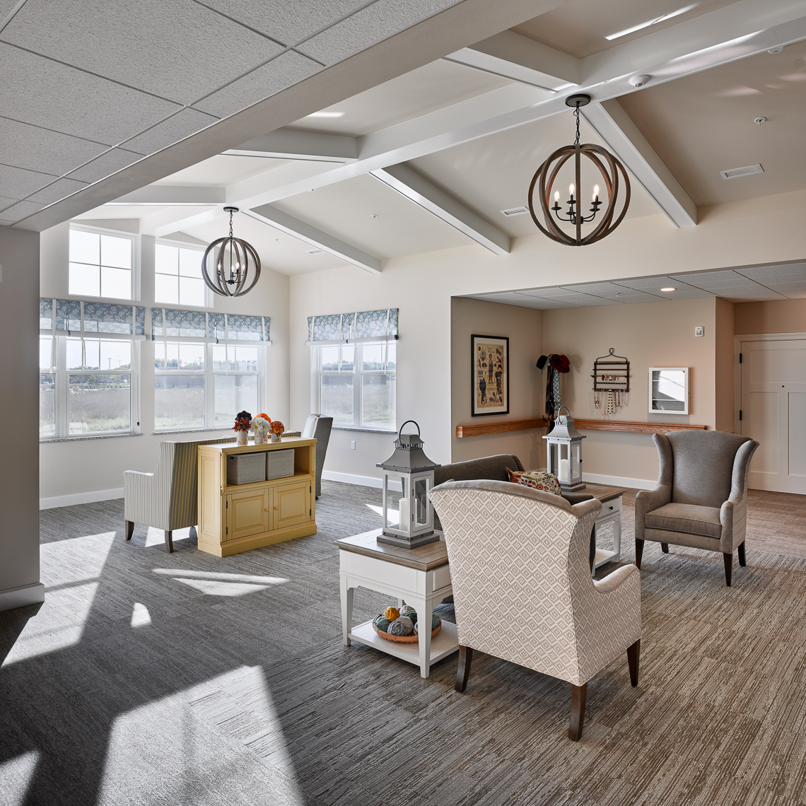 Seating area with vaulted ceiling and windows