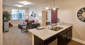 independent living apartment with kitchen island looking into the living room