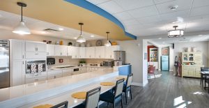 large white cabinet kitchen with island and stools