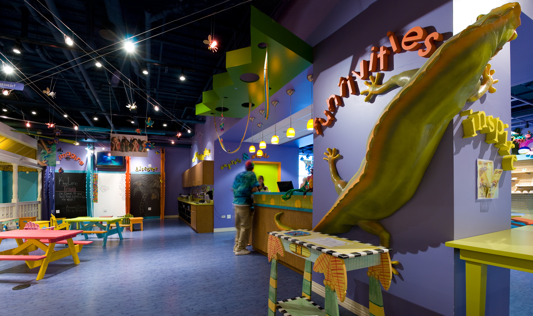 activities room with dark purple walls, seating, and a large lizard on the wall