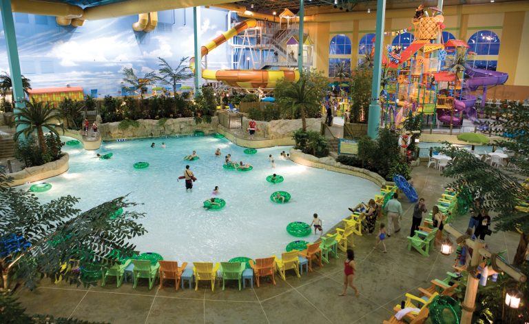 Small wave pool with multi-colored chairs lining the pool