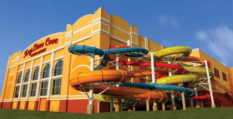 Exterior of Water Park with bright colored slides looping outside of the building