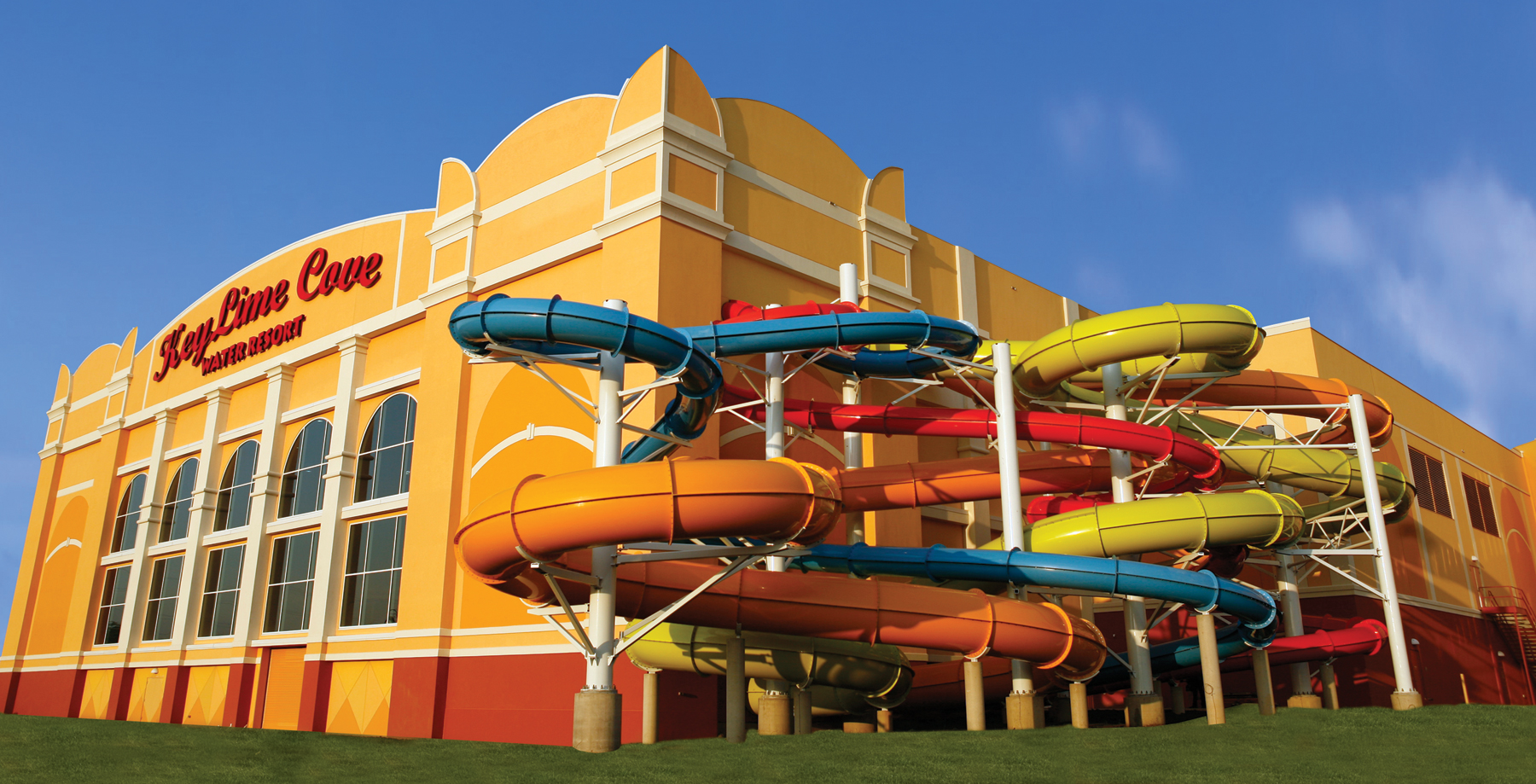 Exterior of Water Park with bright colored slides looping outside of the building