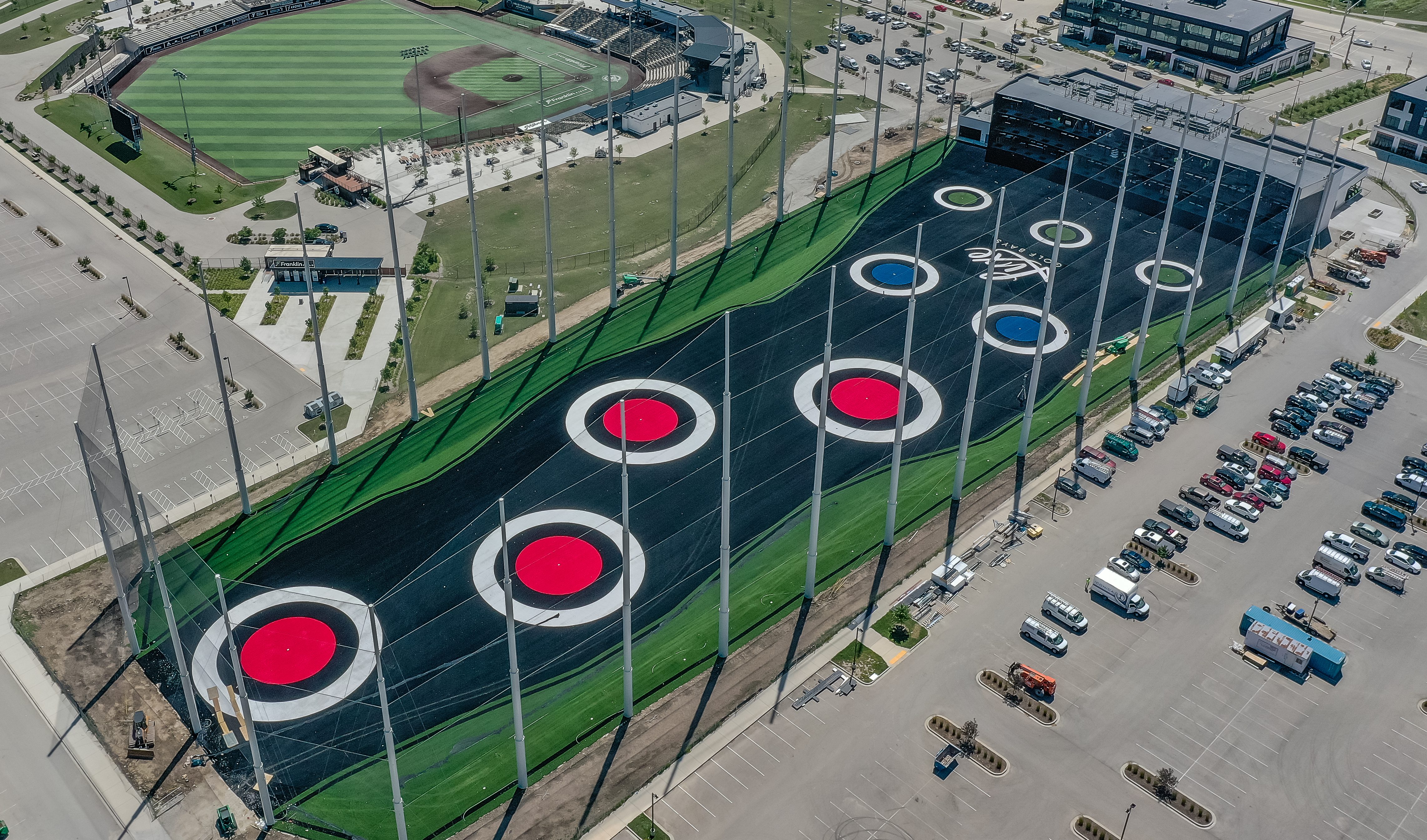 Luxe golf range drone aerial view displaying the entire golf range and building