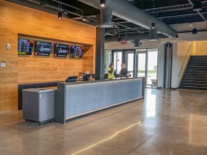 reception for golf check in with wood accent wall and large reception desk