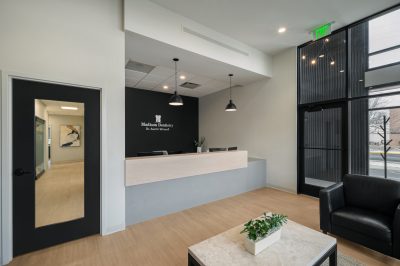 Dental office reception area with black accent wall and light walls