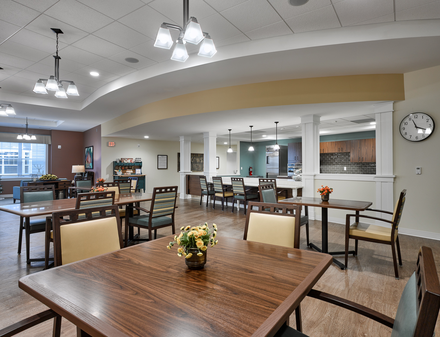 Dinning area with wood tables and light yellow accent chairs