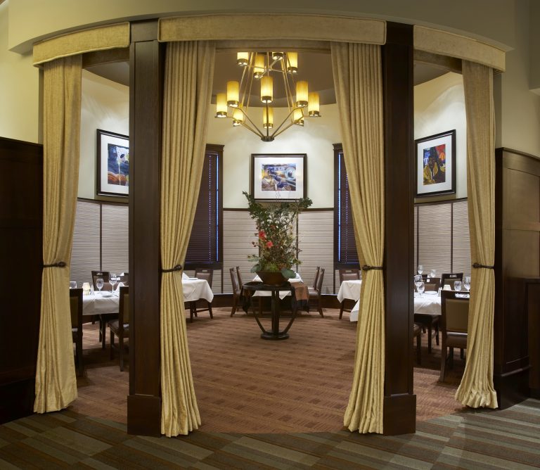 Cigar Lounge with wood panels and drapes along the entrance for privacy