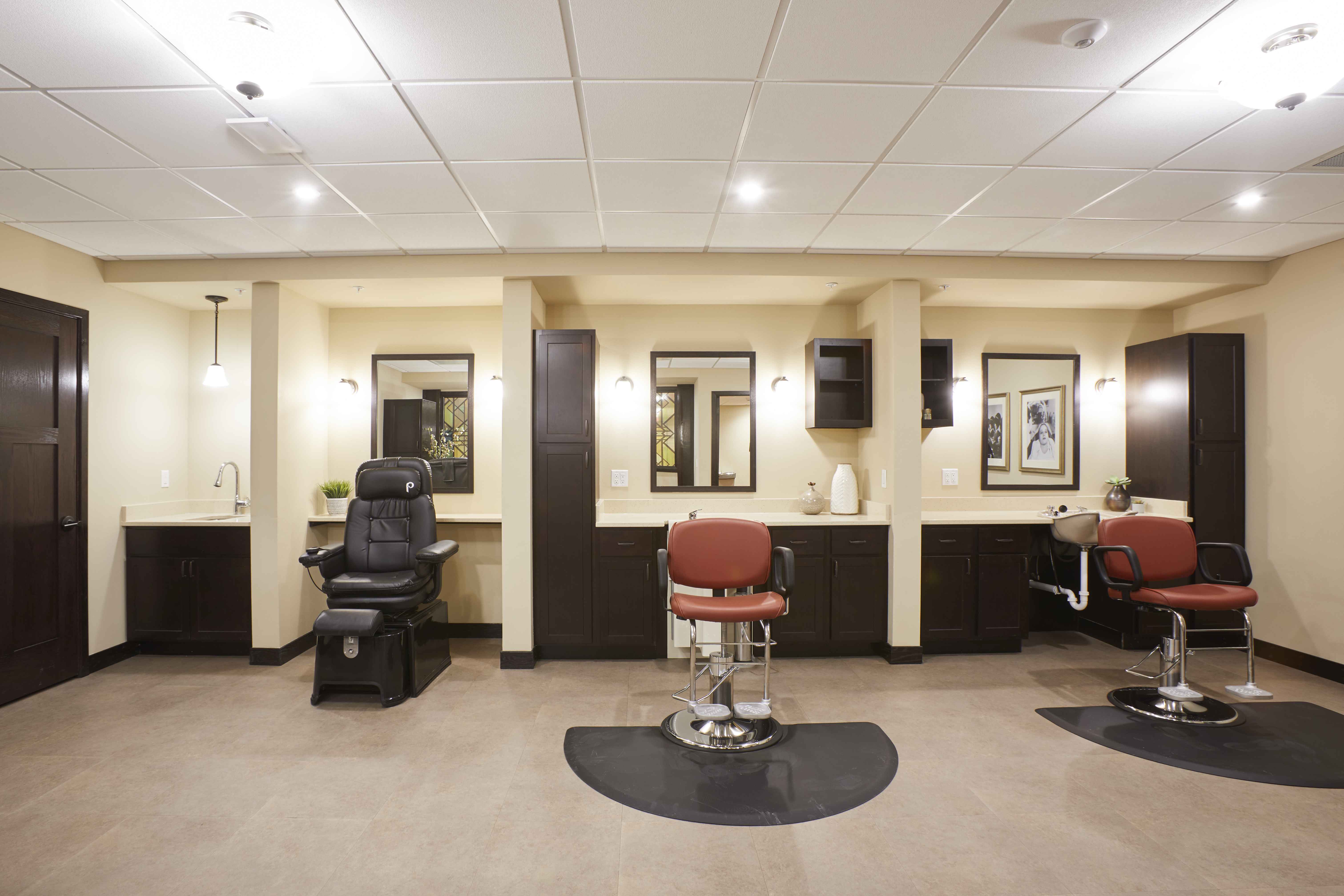 senior living facility salon with burnt orange chairs, mirrors, and cream colored walls