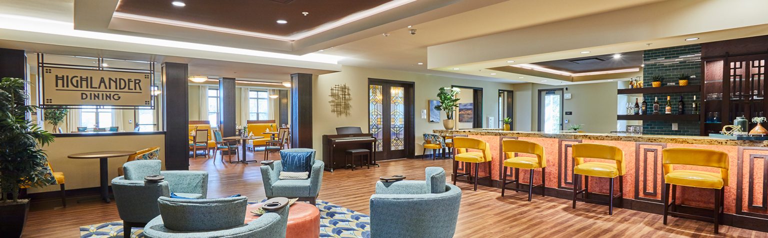 dining area with lounge seating, a bar area with yellow stools