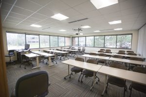 View from front of classroom featuring student seating, and expansive bright windows