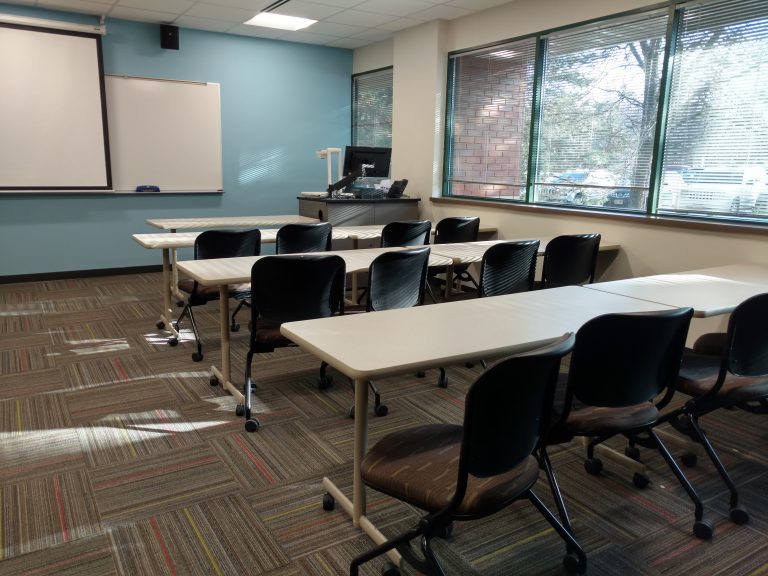 College Classroom with windows light blue accent wall and projector screen