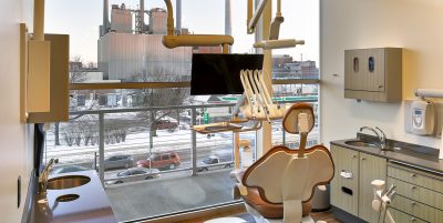 Dental Operatory with floor to ceiling window, dental chair and equipment