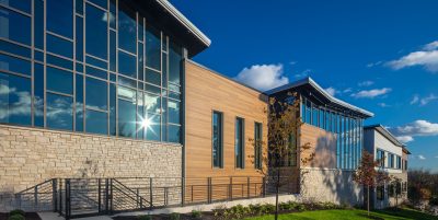 photo-Close up exterior of academy featuring large windows and the building shape