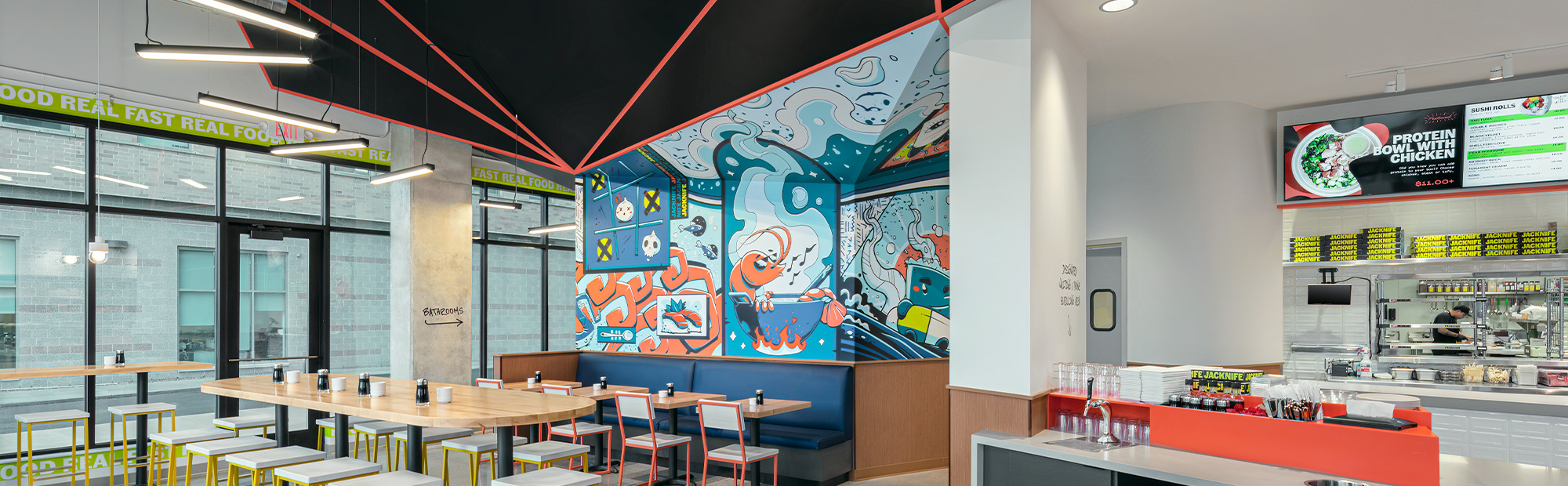 Sushi Restaurant with order counter a bright blur mural wall and seating