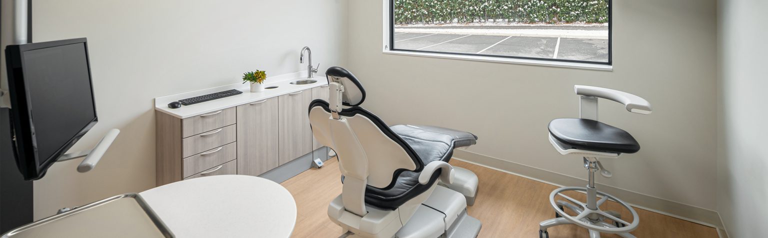 Dental operatory with chair facing window and dental equipment