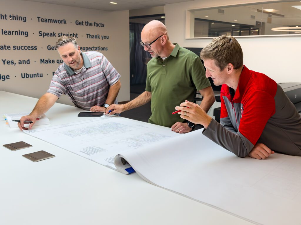 Engineering team meeting to look over floor plans