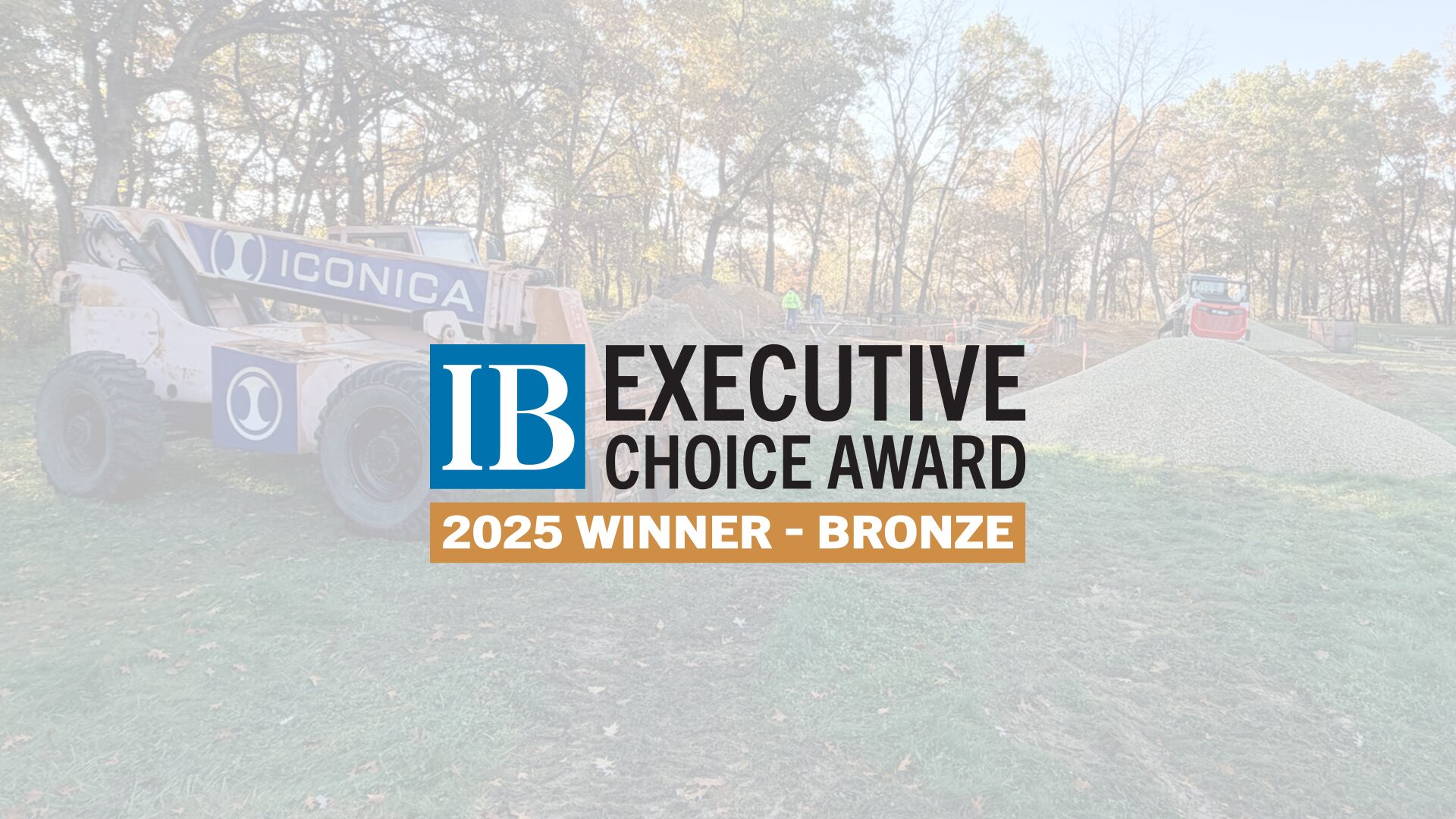In business award cover photo, that shows a construction job site with the award overlaid on top of it