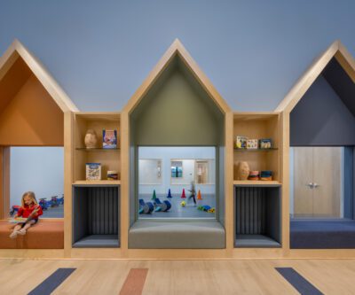 House-shaped reading nooks framing interior view into play gym.