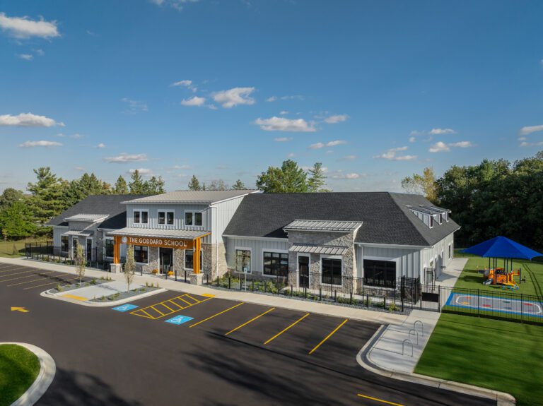 Aerial view of The Goddard School with playground and parking lot.
