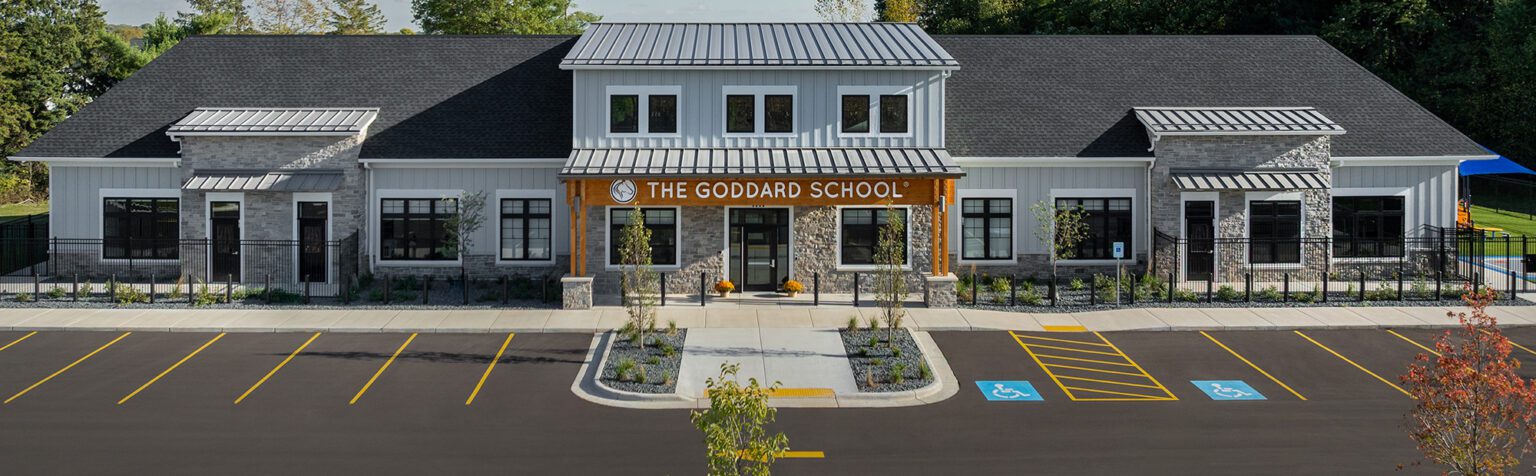 Front elevation of The Goddard School with main entrance and parking.