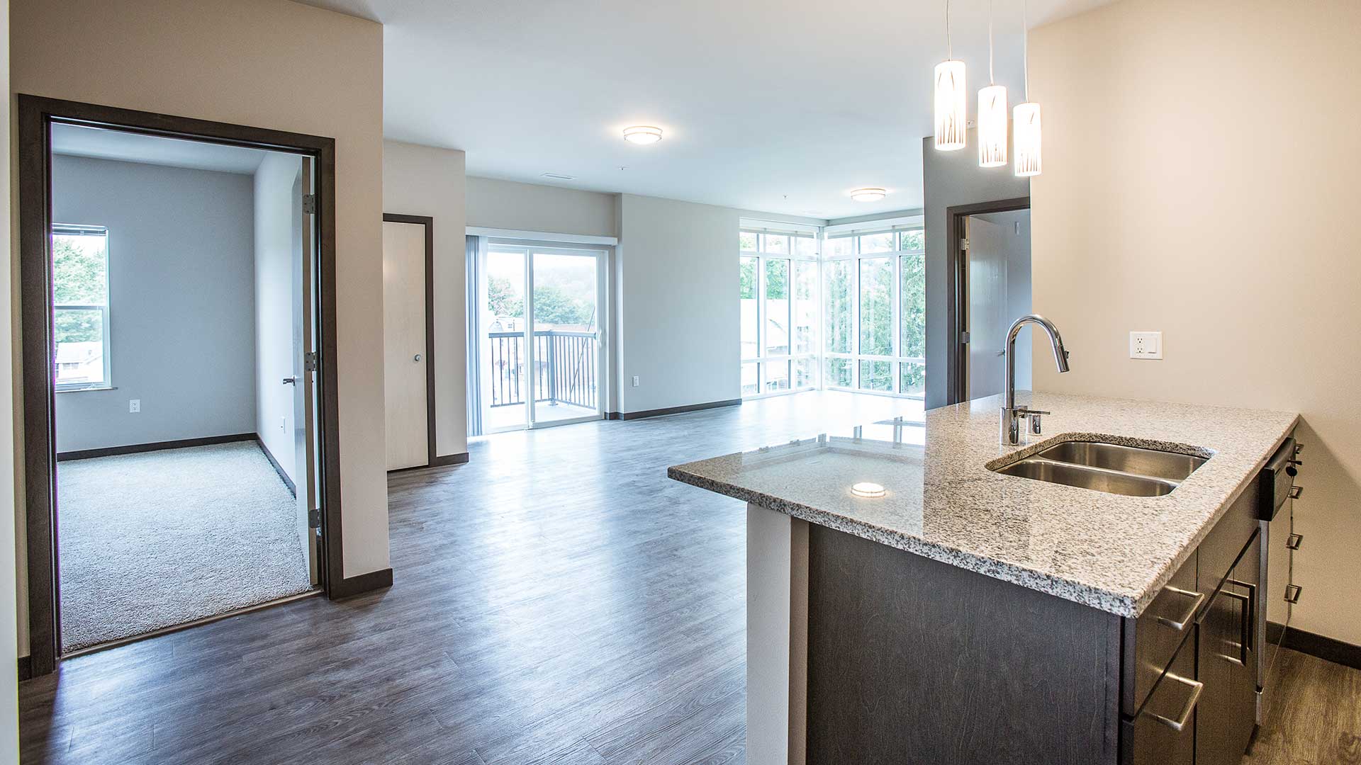 interior of an open concept apartment with a few from the ktichen island into the living room