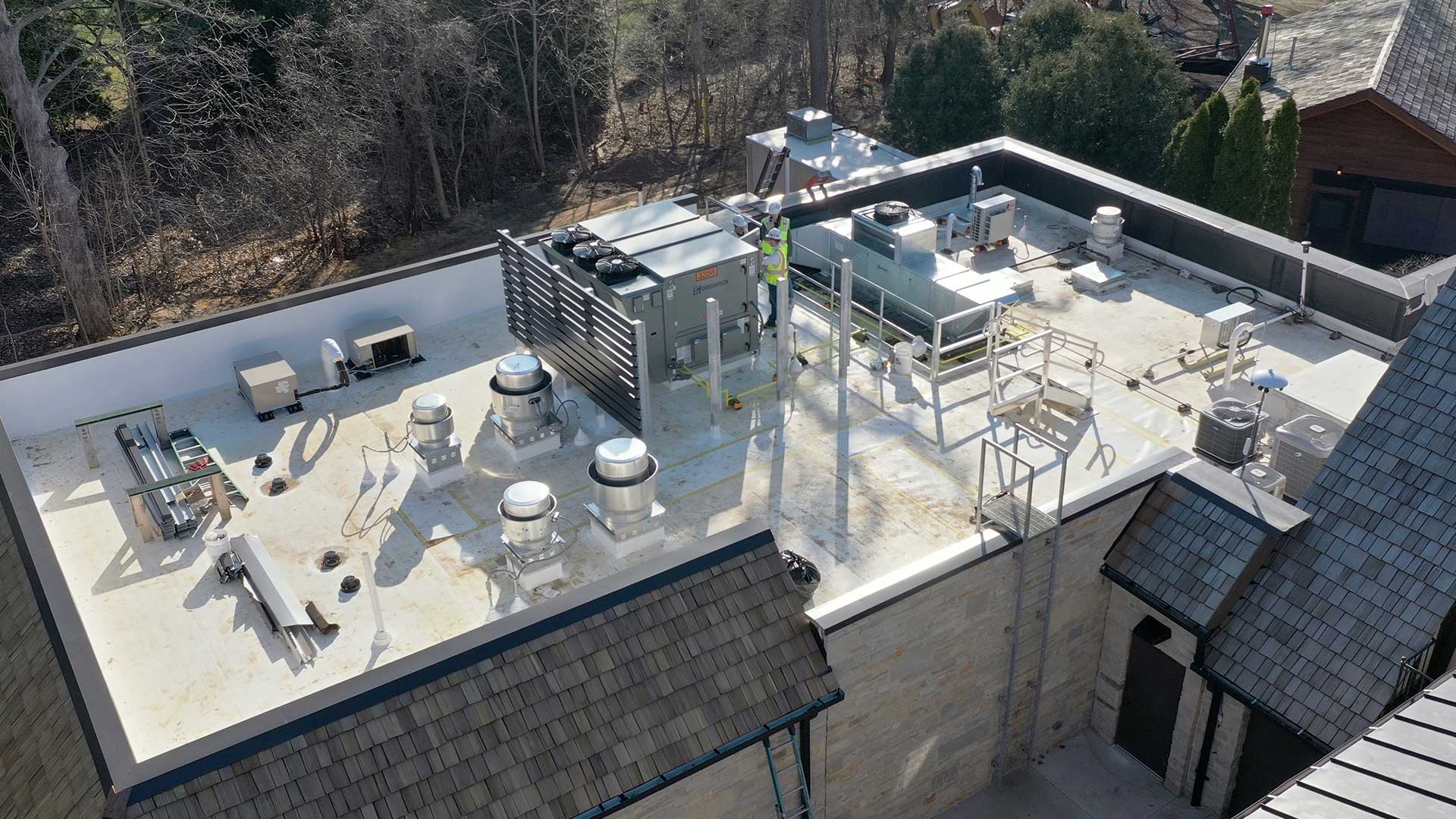 Commercial kitchen rooftop mechanical systems with DOAS and ventilation equipment at Bishops Bay Country Club