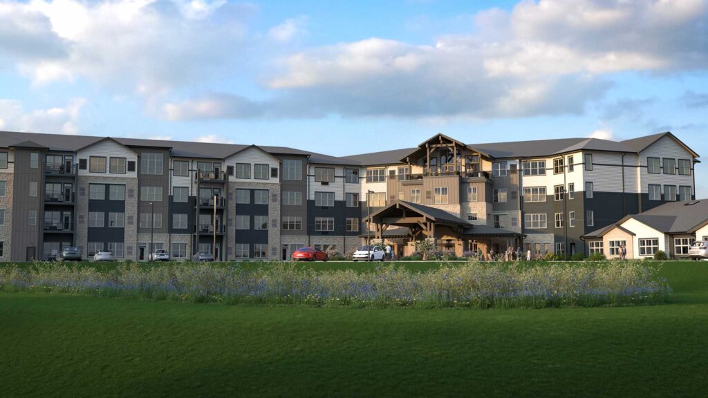 Wide rendering of the LilyRose senior living campus, showing the four-story main residence, timber-frame entry tower, and attached cottage units along a prairie lawn.