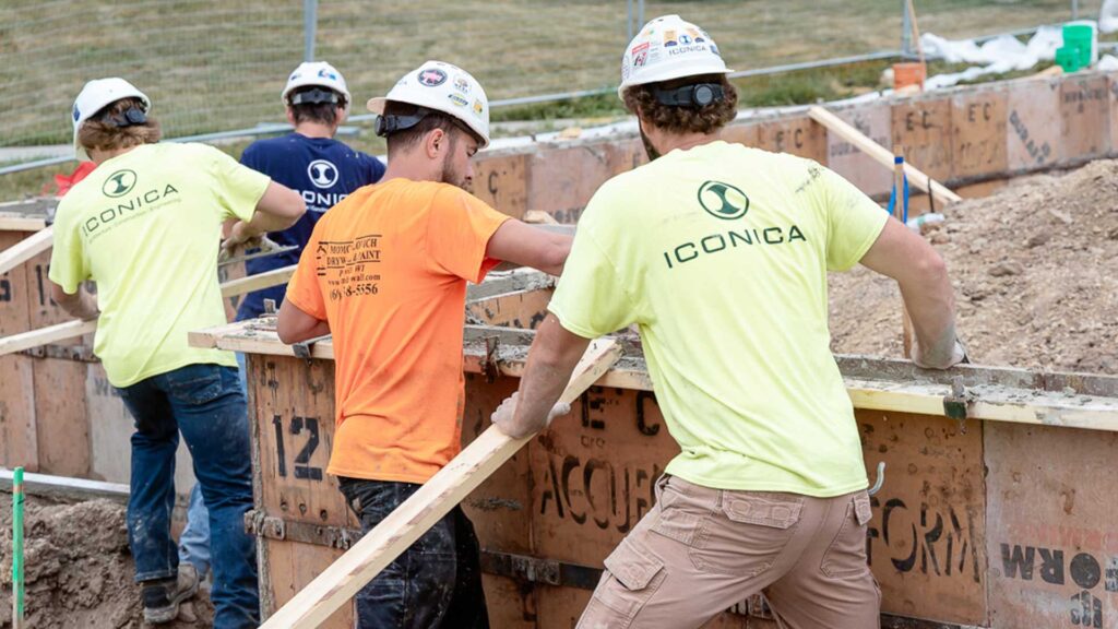 Group of Iconica field staff working on concrete wall pour