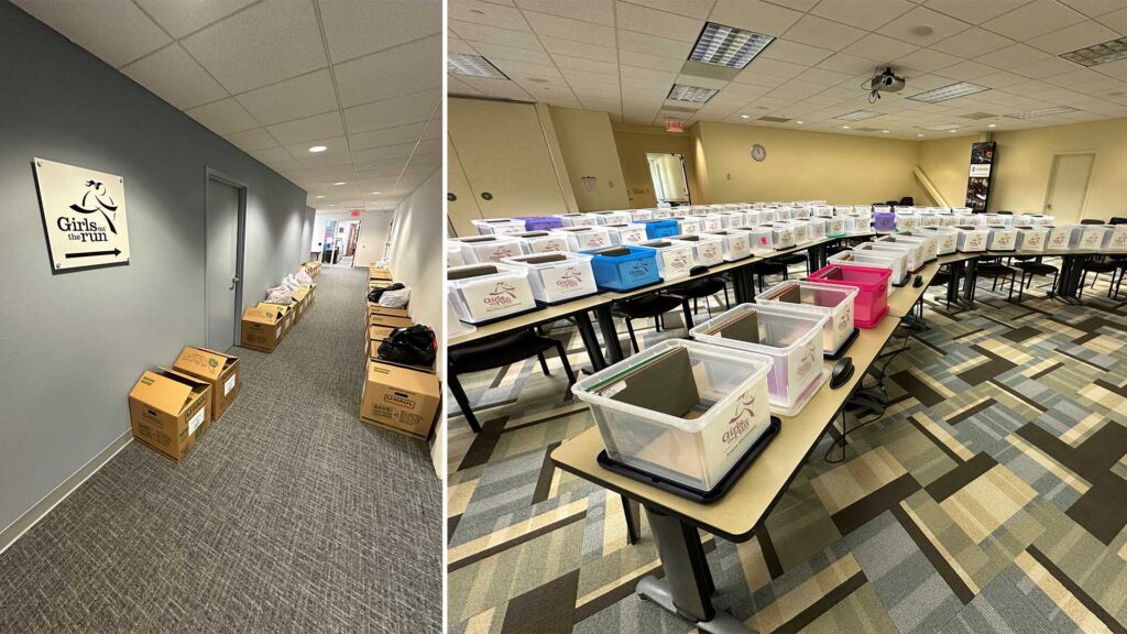 Girls on the Run supplies organized in boxes along a hallway and labeled storage bins arranged across tables in a conference room.